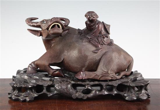 A Chinese carved hardwood group of a boy on an ox back, mid 20th century, total length 36cm